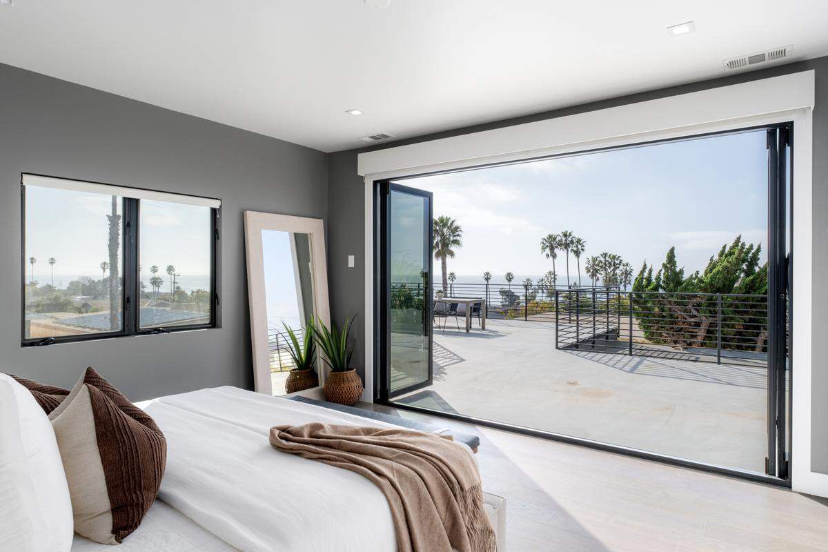 An open-concept main living area seamlessly blends indoor and outdoor spaces, showcasing high-end finishes and abundant natural light.