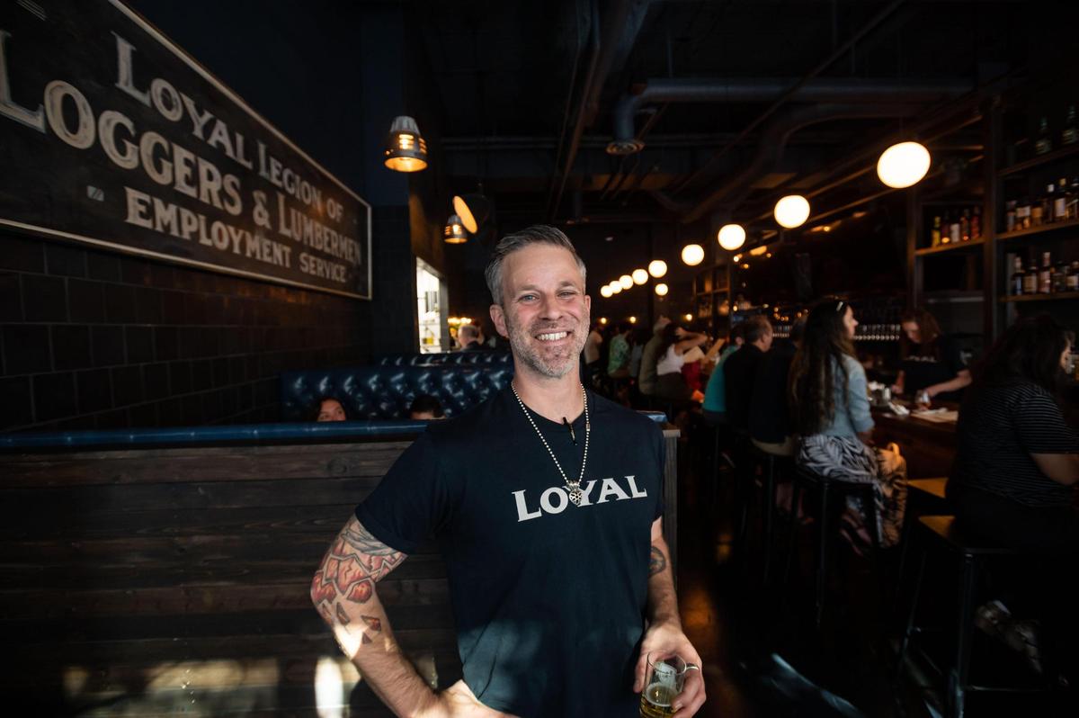 Dustin Newsome, general manager at Loyal Legion Beer Hall, stands between booths and the 55-foot bar during the establishment’s opening Friday in downtown Sacramento.