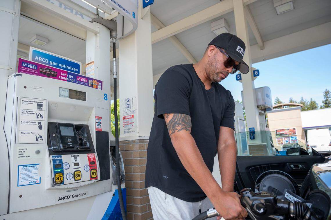 Davis White of Southern California pumps gas for his rental car on Thursday at the Arco gas station at the Sacramento International Airport, where a gallon of regular cost $6.59 the highest price in Sacramento County.