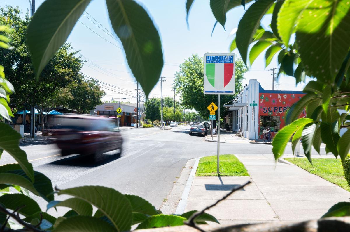 Cars drive past a “Little Italy Historic District” sign at the corner of Folsom Boulevard and 48th Street in East Sacramento in June. The historic district is bound by 48th and 59th streets and by J Street and Folsom Boulevard.