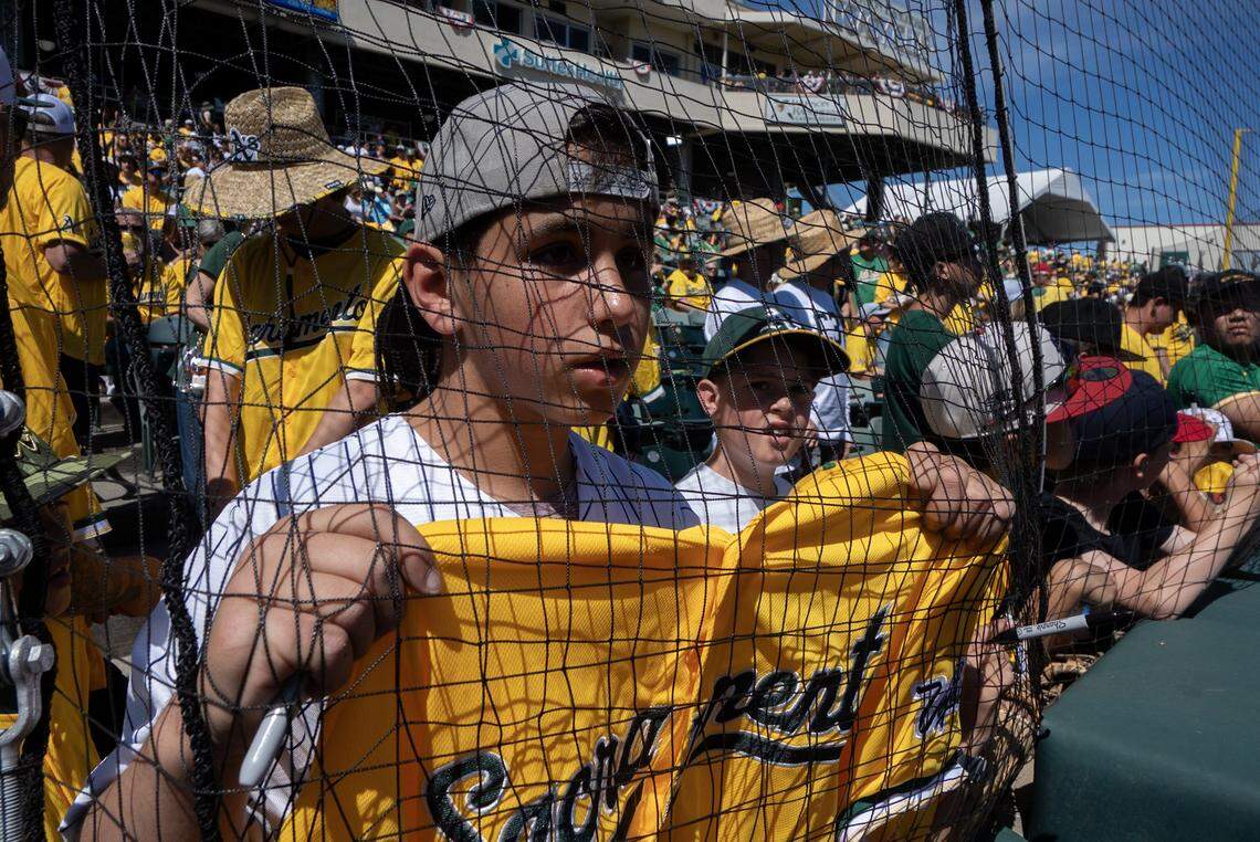 Rocco Sansieir, visiting from New Jersey, tries to get a player’s autograph before the Athletics played the Houston Astros on Saturday, April 4, at Sutter Health Park in West Sacramento.