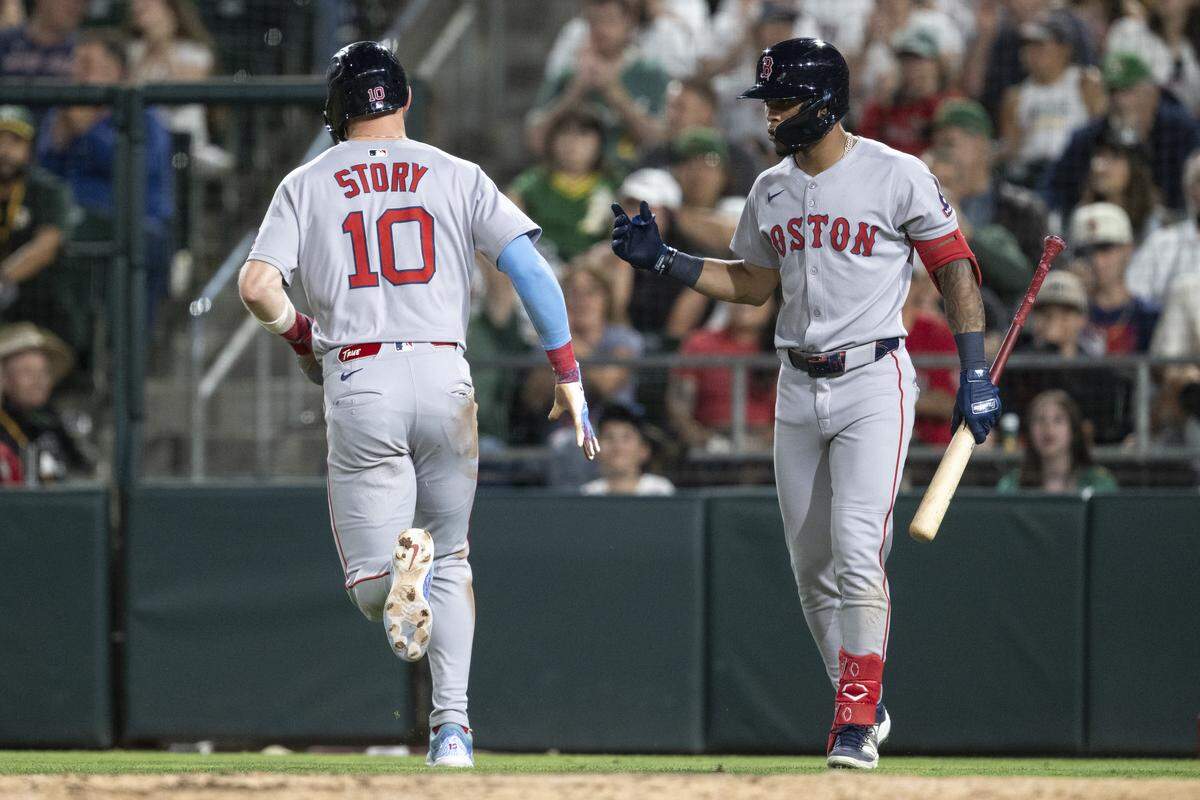 Boston Red Sox shortstop Trevor Story (10) and his teammate react after scoring during a game between the Athletics and the Red Sox at Sutter Health Park in West Sacramento on Monday, Sept. 8, 2025.