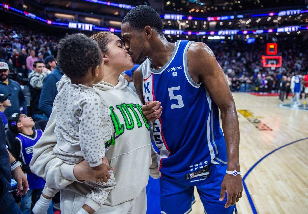 Sacramento Kings guard De’Aaron Fox (5) kisses his wife Recee Caldwell after an NBA game between the Sacramento Kings and the Atlanta Hawks on Monday, Jan. 22, 2024 at Golden 1 Center.