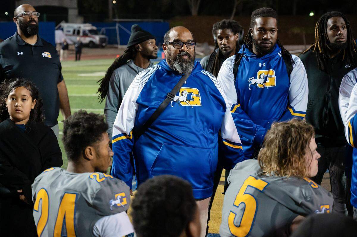 Grant coach Carl Reed, center, listens to assistant coaches talk to the team after the Pacers’ loss to the Monterey Trail Mustangs on Friday at Grant High School in Sacramento. A fatal shooting occurred in the parking lot near the end of the game.
