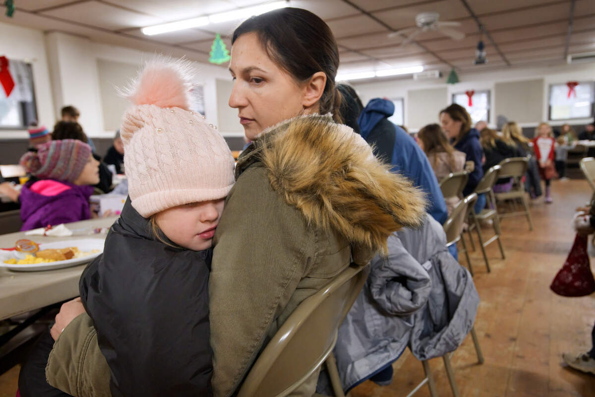 Mila Sorensen 4, left, is held by her aunt Tatyana Andreyev of Somerset during the Breakfast with Santa event at the Fireman’s Hall in Somerset earlier this month. The West Slope Foundation is seeking $5,000 to $10,000 to provide winter coats, boots and other cold weather gear to people displaced by the 2021 Caldor Fire.