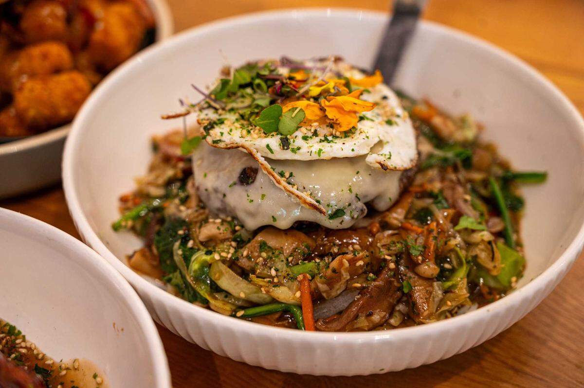 The Hilo Moco is available at Sunny Side Breakfast in Sacramento on Tuesday. A Wagyu beef patty topped with melted cheddar cheese and a crispy fried egg is served over a bed of rice and vegetables.