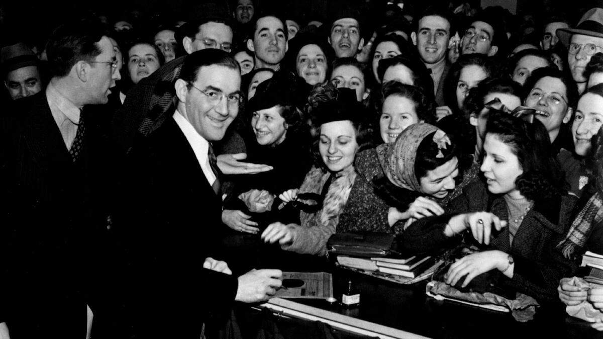 Big band leader and “King of Swing” Benny Goodman holds a record autograph session in the late 1930s.
