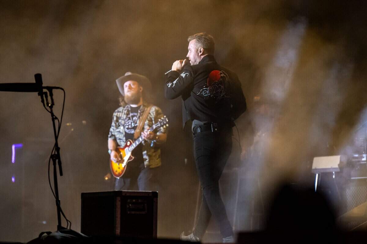 T.J. Osborne, right, of Brothers Osborne sings as John Osborne plays guitar on the Visit Sacramento Stage during Sacramento’s first-ever GoldenSky country music festival Saturday, Oct. 15, 2022, at Discovery Park. The two-day event featured headliners Tim McGraw and Sam Hunt, as well as Midland, Carly Pearce and more.