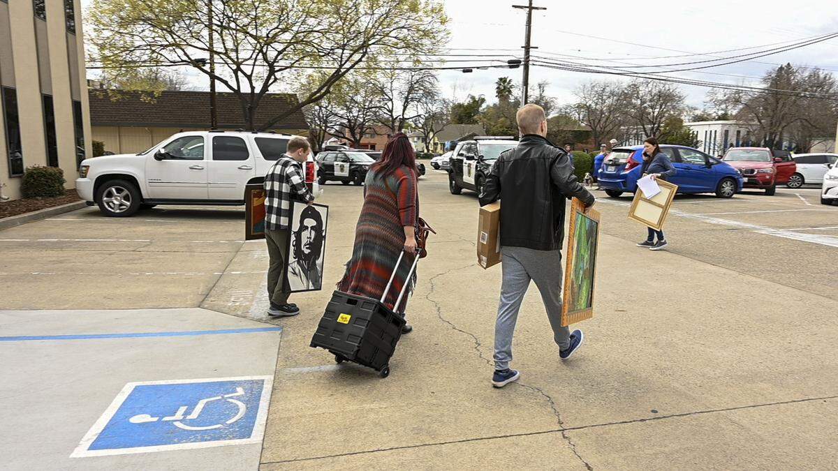 SEIU Local 1000 staff members exit the union’s Sacramento headquarters with personal belongings on March 5 after police allowed them inside to get their things during a protest that escalated when a group of protesters occupied the building. They were protesting the suspension of SEIU Local 1000 President Richard Louis Brown.