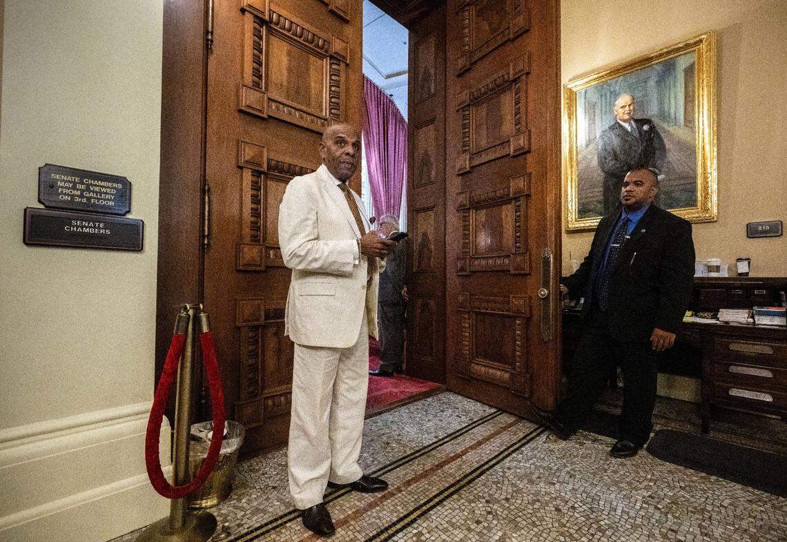 State Sen. Steven Bradford, D-Gardena, looks at his phone as he steps outside the Senate chambers on Friday at the state Capitol. Bradford was waiting to see if two if his reparations-related bills will pass on the Assembly floor.
