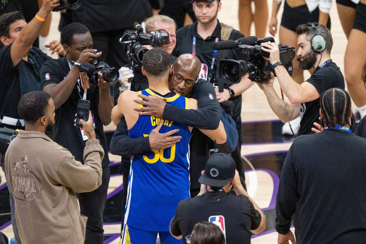 Sacramento Kings head coach Mike Brown hugs Golden State Warriors guard Stephen Curry (30) after the Kings beat the Warriors in an NBA play-in game at Golden 1 Center on April 16.