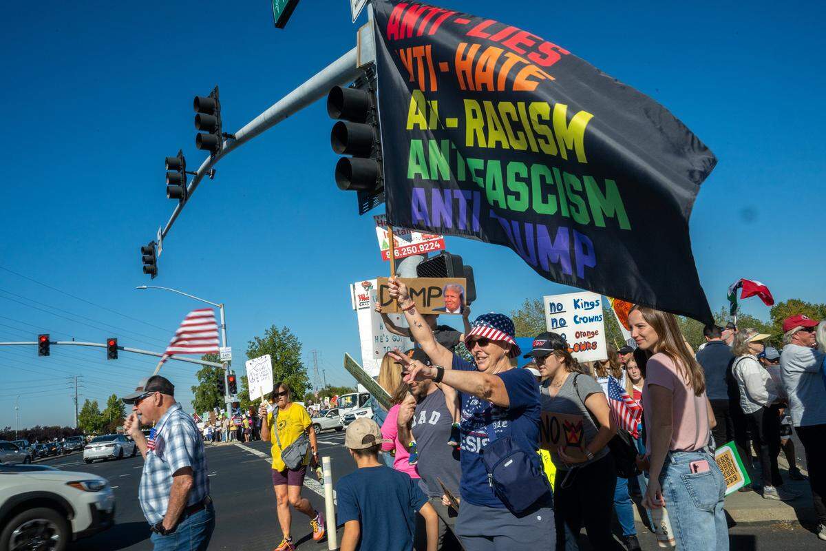 Demonstrators participate in a “No Kings” protest in Roseville on Saturday, Oct. 18, 2025.