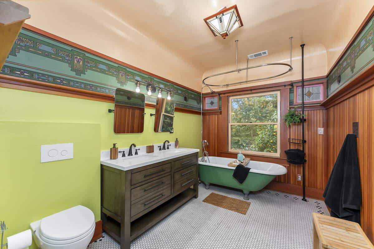 The vintage bathroom upstairs with original tile and an authentic clawfoot bathtub.