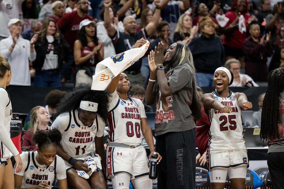 The South Carolina Gamecocks celebrate as the final buzzer goes off in the win over the Oklahoma Sooners in an NCAA Women’s Basketball Tournament Sweet 16 game Saturday at Golden 1 Center in Sacramento.