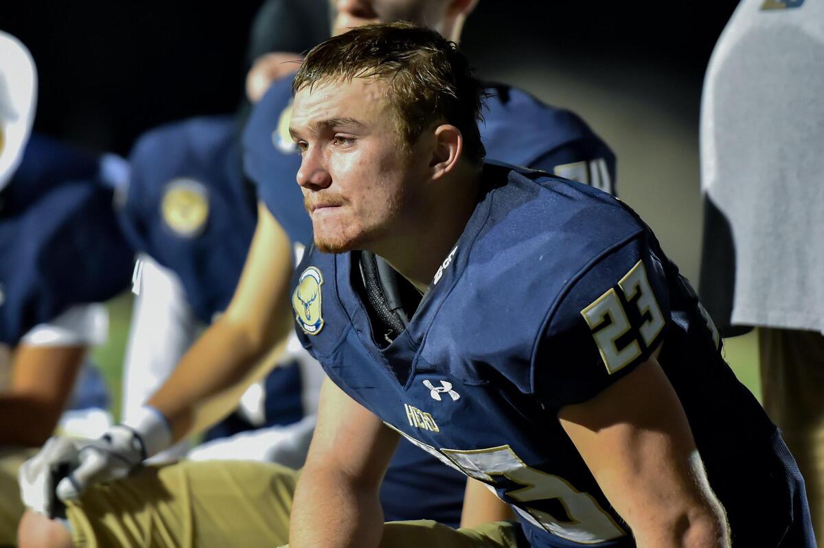 The Elk Grove Thundering Herd’s Ethan Scott (23) shows emotion after his team lost its first-round CIF Sac-Joaquin Division II section football playoff game against the Vacaville Bulldogs on Friday.