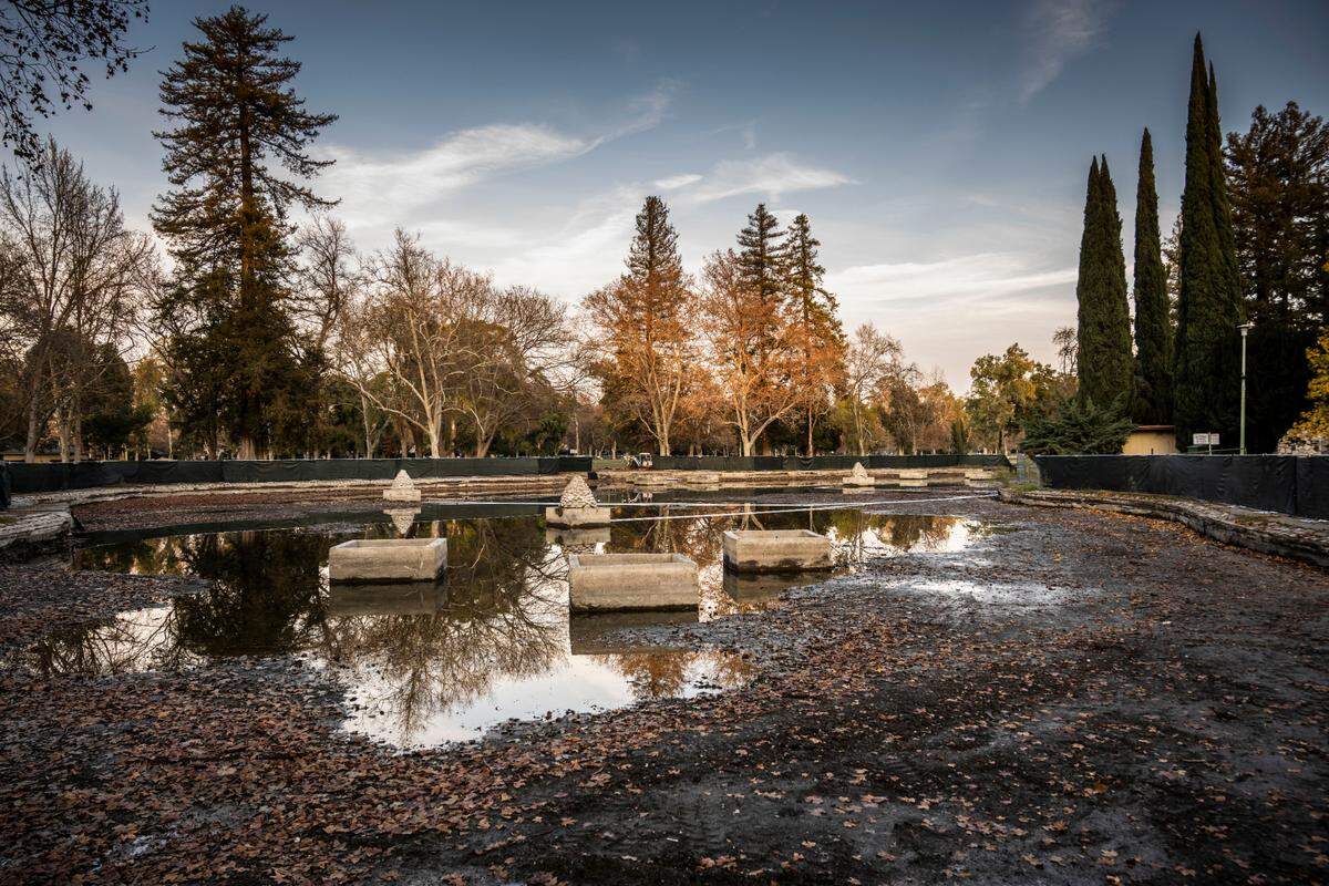 The William Land Park duck and lily pond, photographed by drone inside the fenced perimeter on Wednesday, was drained in an effort to protect Sacramento Zoo animals from avian flu. The city is also doing some necessary maintenance and repairs.