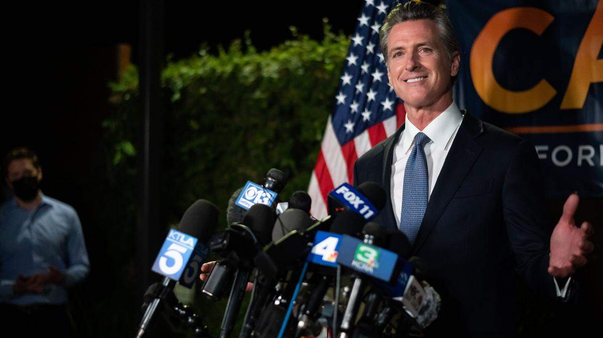 Gov. Gavin Newsom gives a statement to news media shortly after polls closed across the state, with early results giving him a clear lead and the Associated Press calling the recall election in his favor, on Tuesday, Sept. 14, 2021, at the California Democratic Party Headquarters in Sacramento.