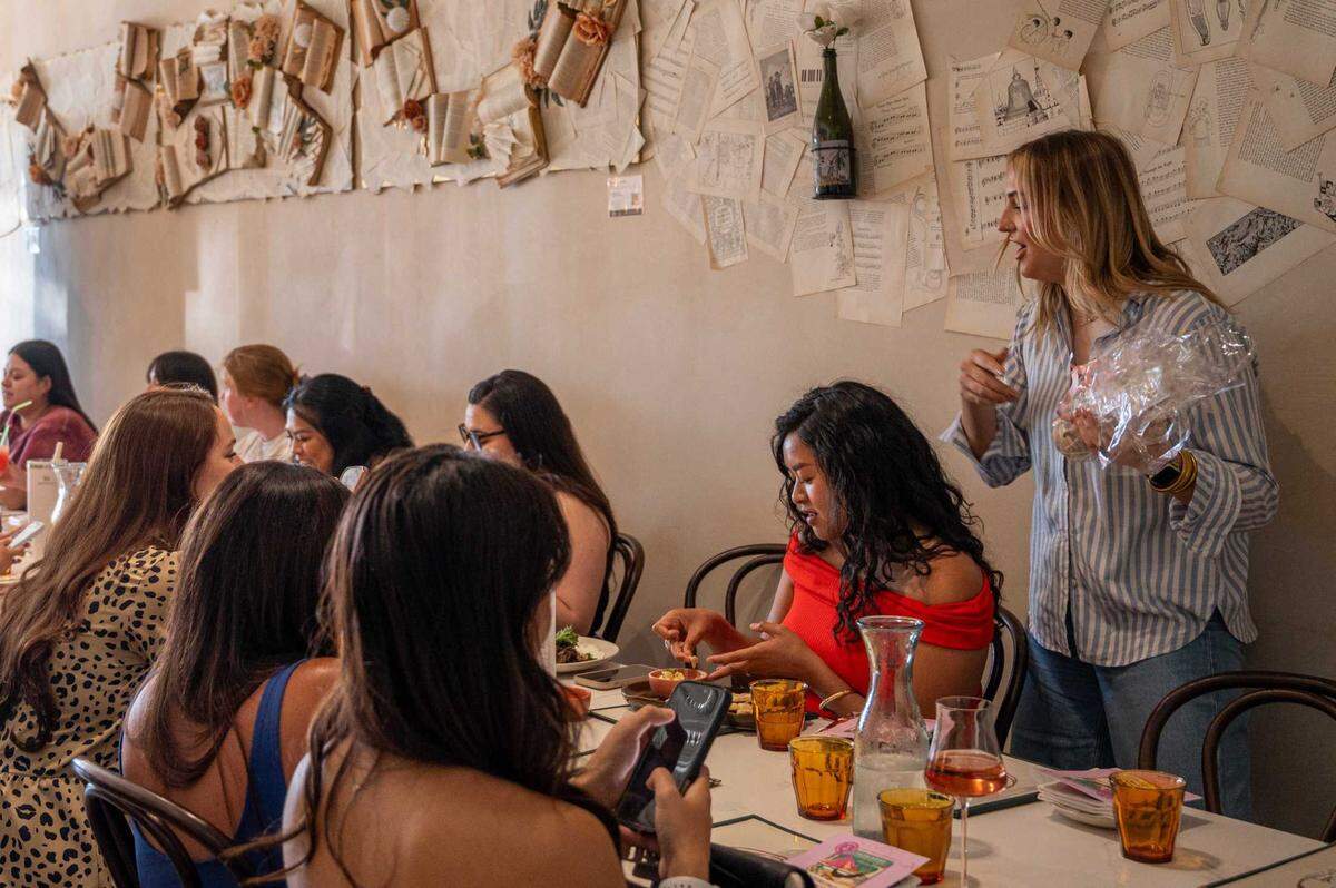 Monica Tarrant, founder of Book and Sip Club, leads Elk Grove chapter meeting at Ever After Wine in Elk Grove on Wednesday. Elk Grove Book and Sip Club meets once a month to discuss books at a local business.