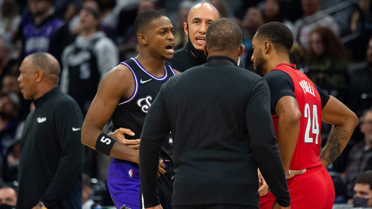 Assistant coach Doug Christie leads Sacramento Kings guard De’Aaron Fox (5) off the court after he is ejected from the game at the Golden 1 Center on Wednesday, November 24, 2021, in Sacramento.
