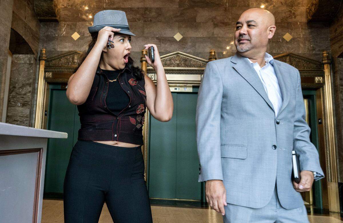 Amy-Elizabeth Torrico tries on her father Alberto Torrico’s hat last month. Torrico is of Bolivian and Japanese descent.