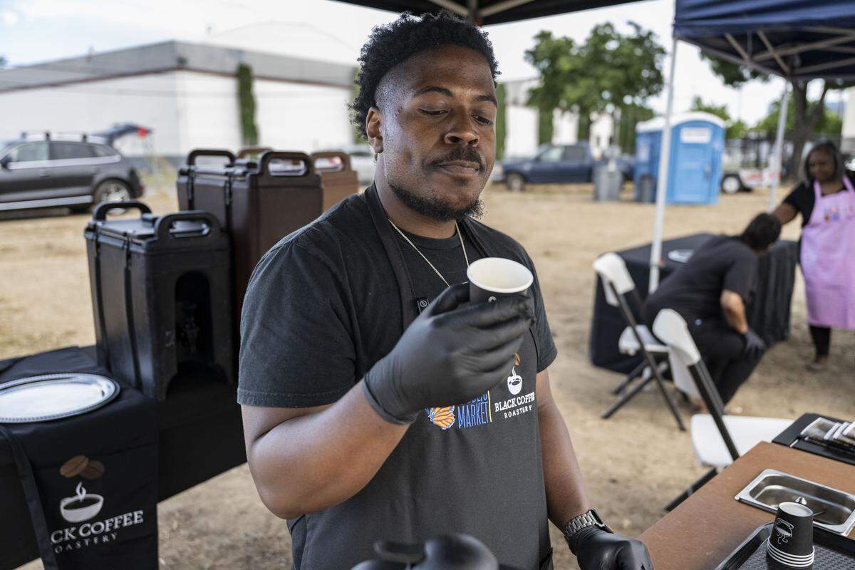 Dante Williams, owner of Black Coffee Roastery, describes the flavor of his Honduran coffee blend during the groundbreaking of Alchemist Public Market in Sacramento’s River District on Thursday.