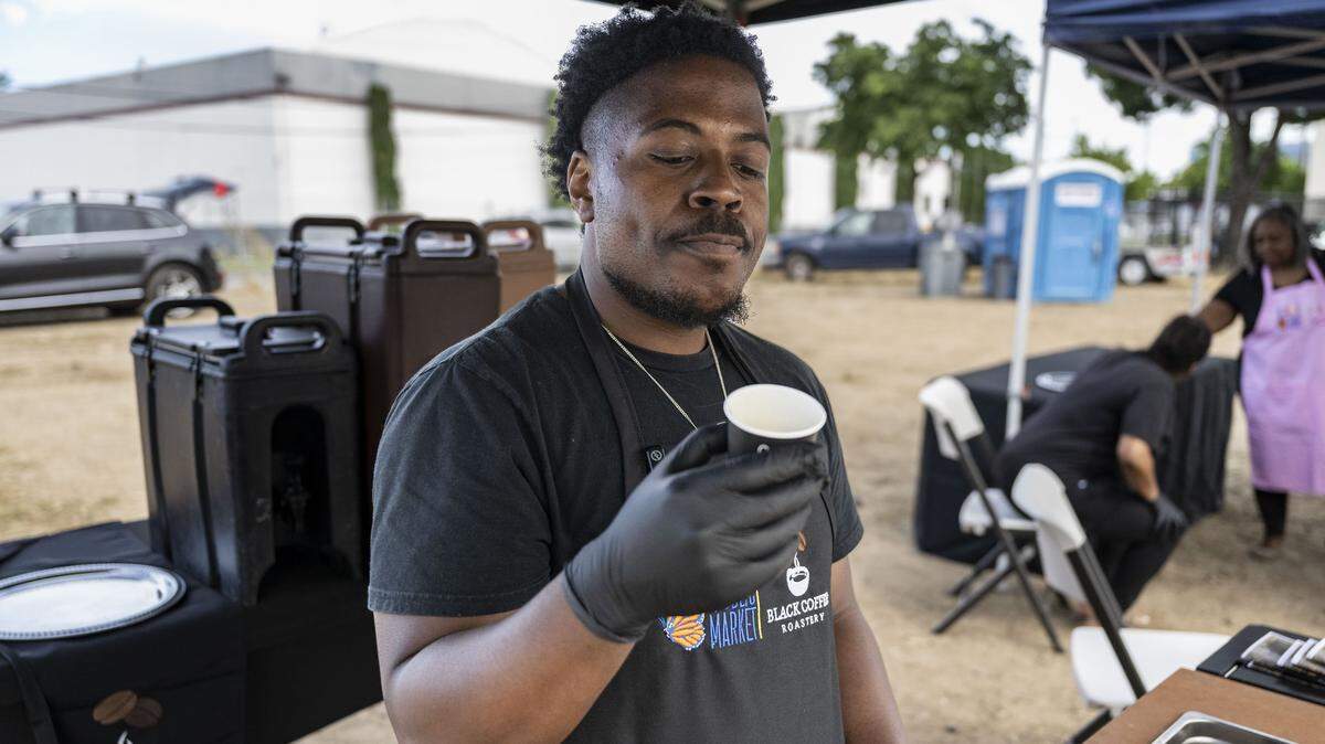 Dante Williams, owner of Black Coffee Roastery, describes the flavor of his Honduran coffee blend during the groundbreaking of Alchemist Public Market in Sacramento’s River District on Thursday, April 9, 2026.