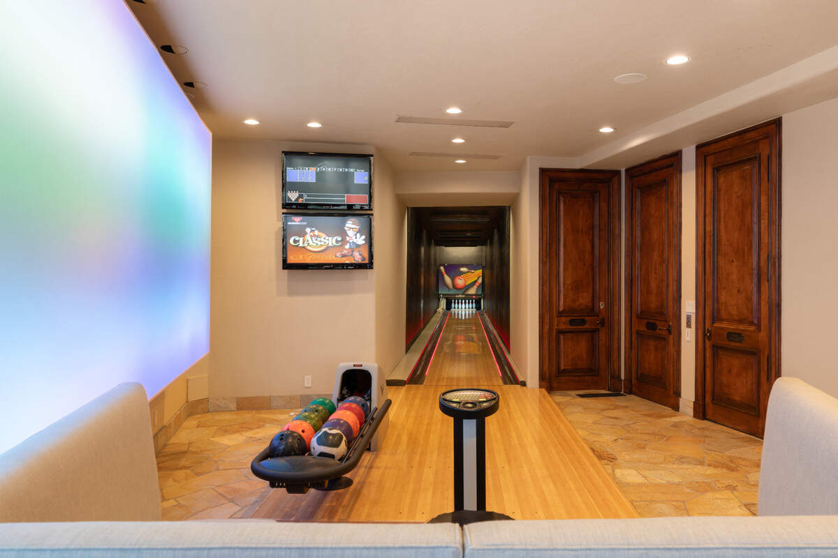 The log cabin style estate has an epic game room and a bowling alley.