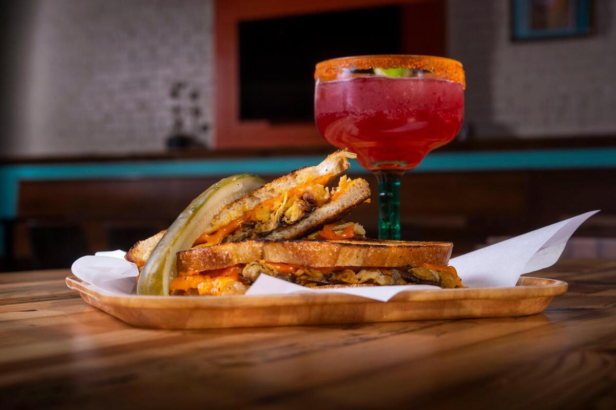 A Malty Melt is Bambi Vegan Tacos’ vegan take on a tuna melt, with charred artichokes, sweet onions, oyster mushrooms, garbanzo beans and a lemon-caper-garlic-dill aioli, served on sourdough bread. It’s served here with with a blackberry margarita.