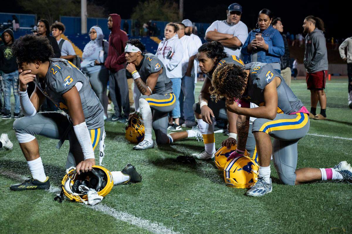 Grant football team members look dejected after losing their home game against Monterey Trail on Friday at Grant High School in Sacramento. A fatal shooting occurred in the parking lot near the end of the game.