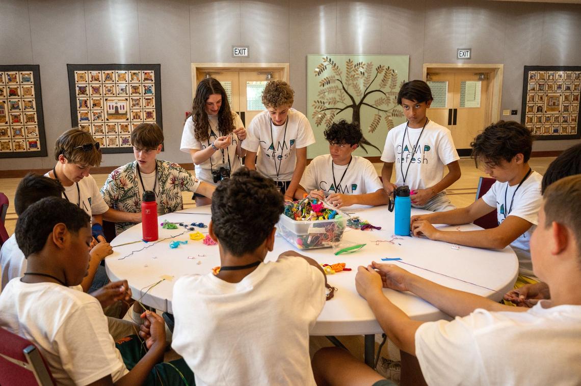 Campers and counselors make friendship bracelets at Camp Nefesh in Sacramento on June 19, 2024.