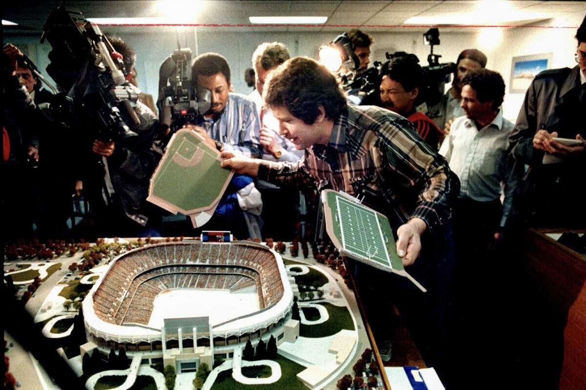 Gregg Lukenbill changes the configuration on the field on a model of the stadium that is under construction in North Natomas during a news conference on March 2, 1990. Lukenbill changed the field from football to baseball after reports indicated that the Raiders had decided to move back to Oakland from Los Angeles.