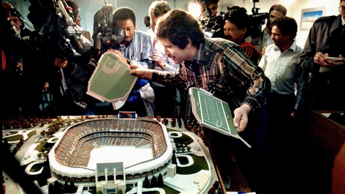 Greg Lukenbill changes the configuration on the field on a model of the stadium that is under construction in North Natomas during a news conference on March 2, 1990. Lukenbill changed the field from football to baseball after reports indicated that the Raiders had decided to move back to Oakland from Los Angeles. 