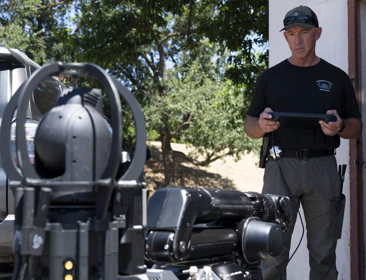 Sacramento County Sheriff’s Lt. Tom McCue demonstrates the office’s new robot canine, Buster, on Tuesday. The robot will be operated by the sheriff’s office bomb squad.