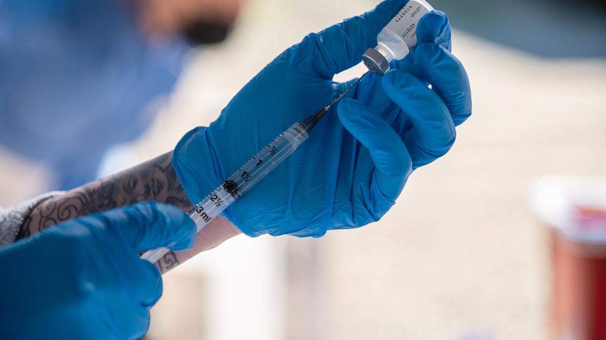 Yolo County EMS Administrator Kristin Weivoda prepares a COVID-19 vaccinate on Wednesday, Feb. 17, 2021.
