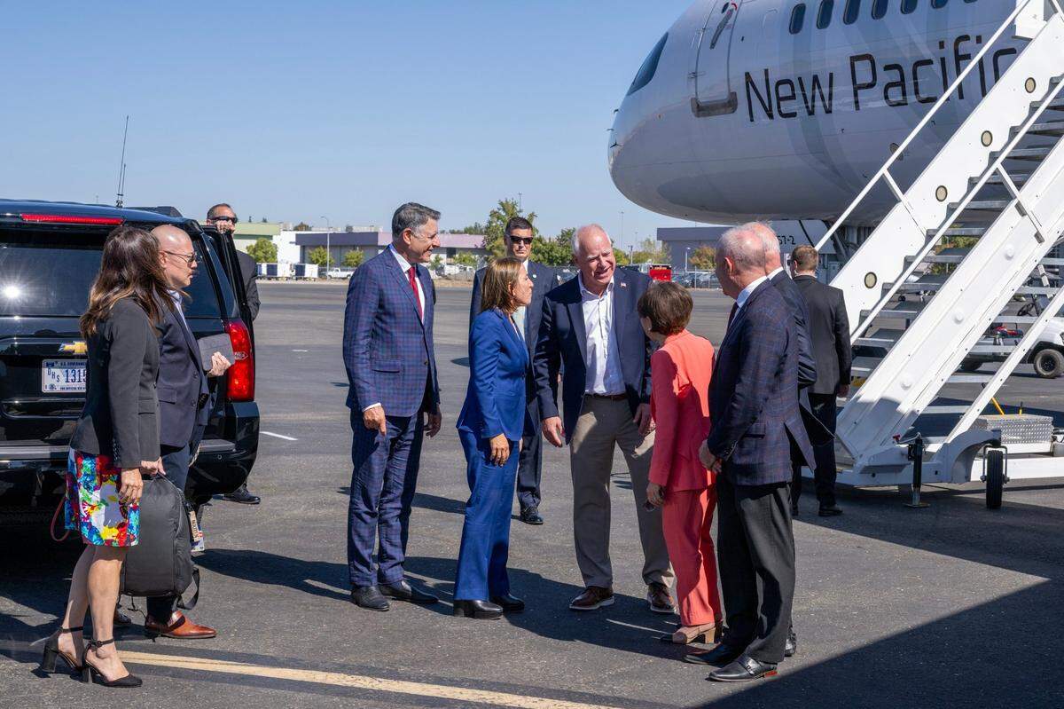 Democratic vice presidential candidate Tim Walz, governor of Minnesota, speaks with Congresswoman Doris Matsui, D-Sacramento, and local dignitaries at Sacramento International Airport during a stop to meet with donors on Tuesday.