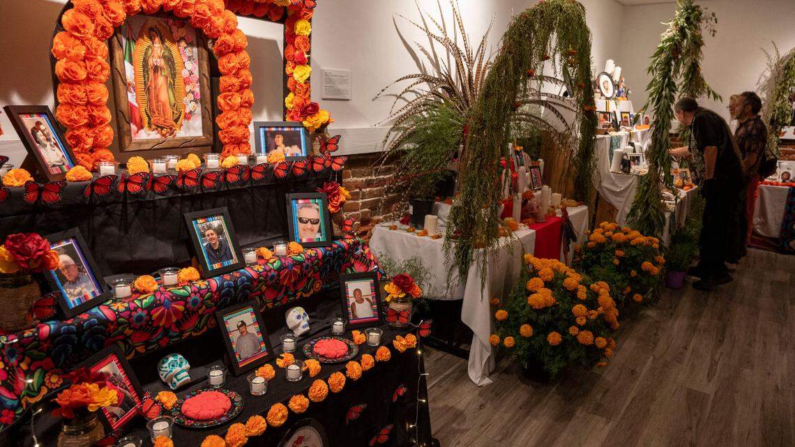 People look at the ofrendas, Day of the Dead altars to deceased loved ones, at an art reception at the Center Street Gallery on Thursday, Oct. 19, 2023, for Placerville, California’s Dia de los Muertos celebration.