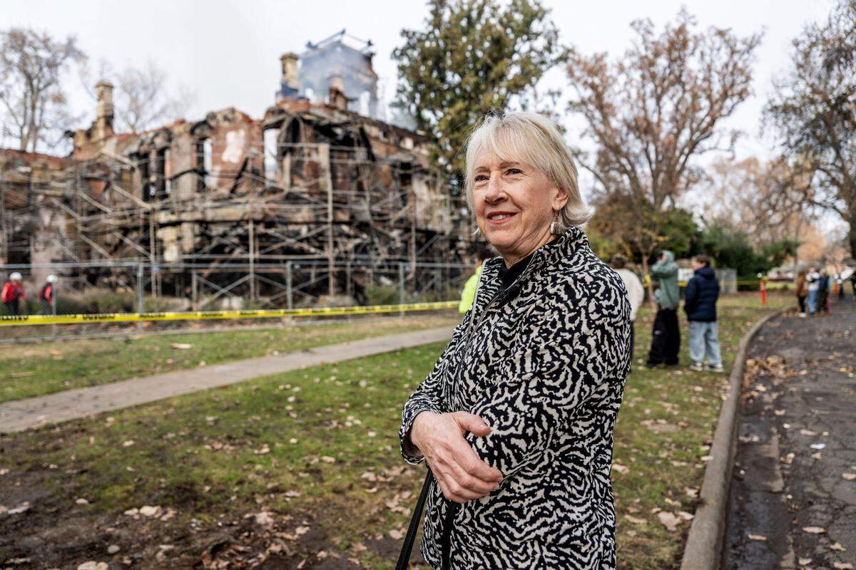 Claire Ramsey stands in front of the burned historic Bidwell Mansion on Wednesday, Dec. 11, 2024 in Chico. Ramsey said she feels so sad to think about the things lost in the fire, such as the self portrait of Gen. John Bidwell, “the father of Chico.”
