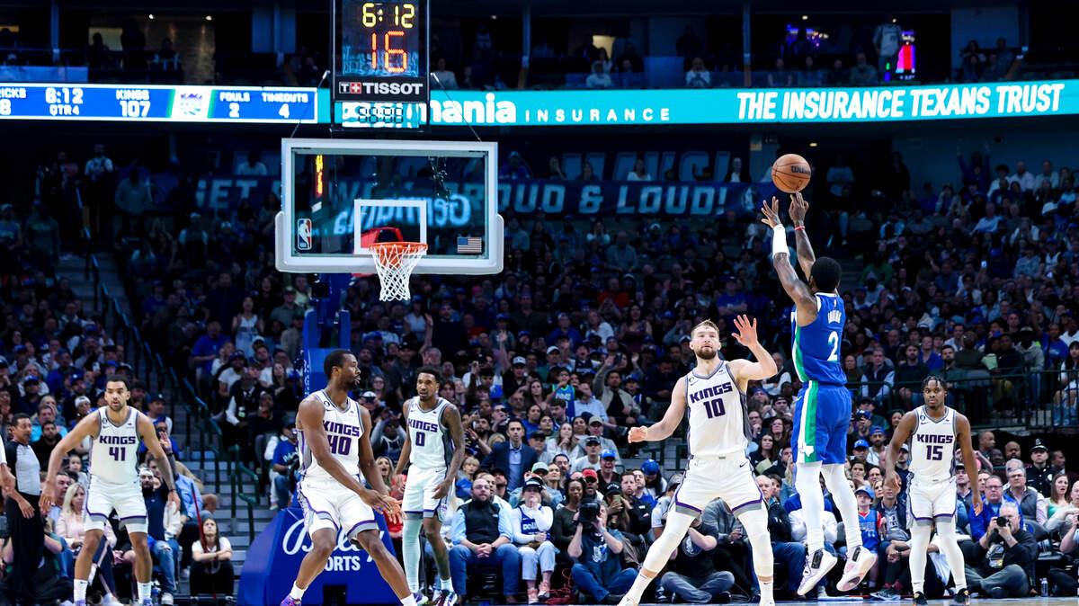 Dallas Mavericks guard Kyrie Irving (2) shoots over Sacramento Kings forward Domantas Sabonis (10) during the second half at American Airlines Center on April 5, 2023.