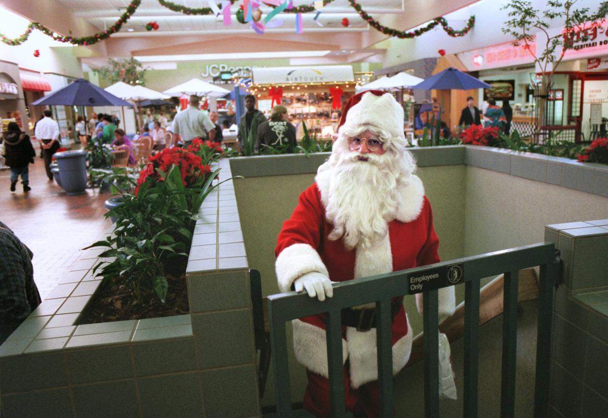 Santa Claus emerges at Florin Mall on his way to visit children in 1999. John DeLong said he enjoyed the job and the kids were great.