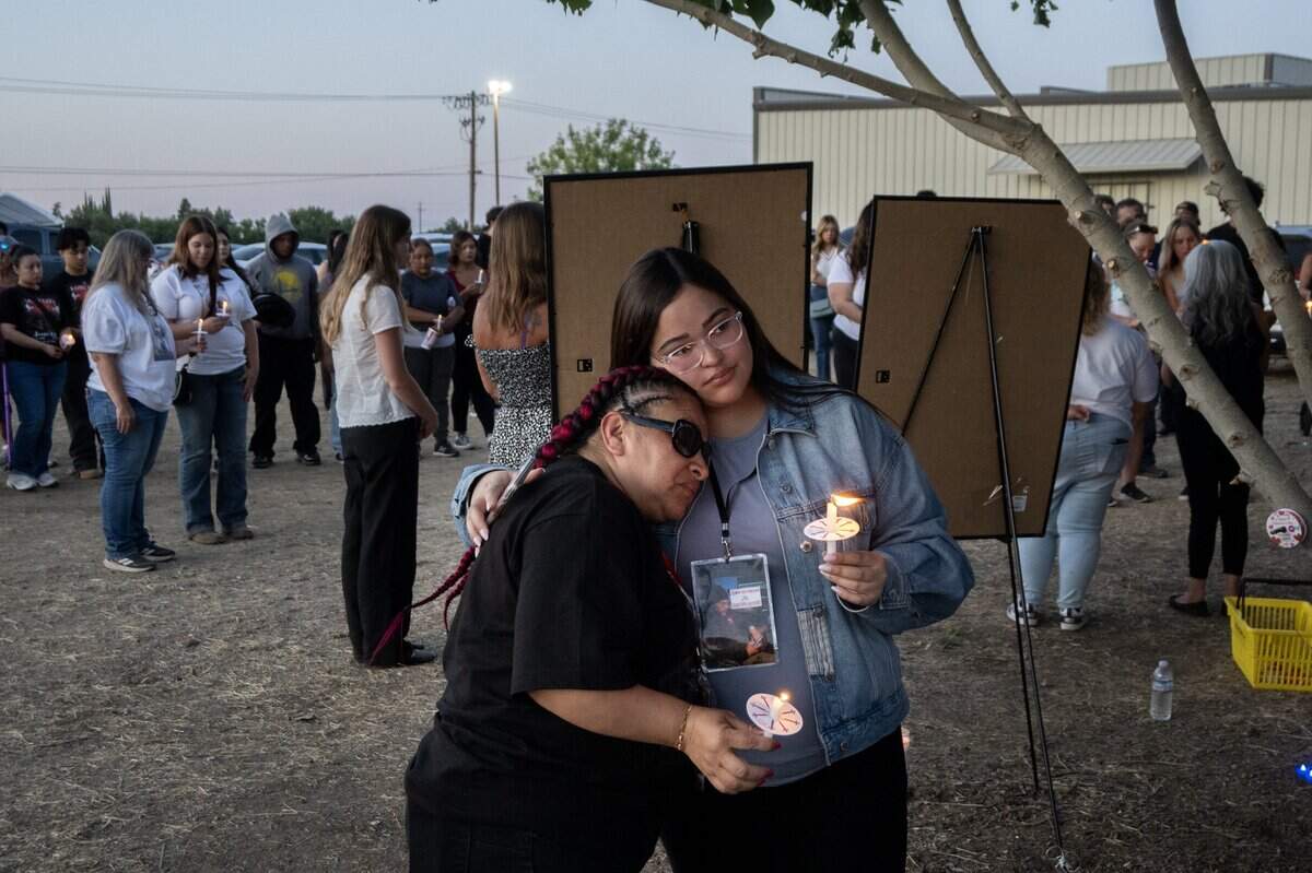 Marisol Ramos, mother of fireworks explosion victims Jesus and Jhony Ramos, is embraced by Cindy Antunes as family, friends and community members gather to pay their respects during a vigil marking the first anniversary of the Esparto fireworks explosion on Wednesday.