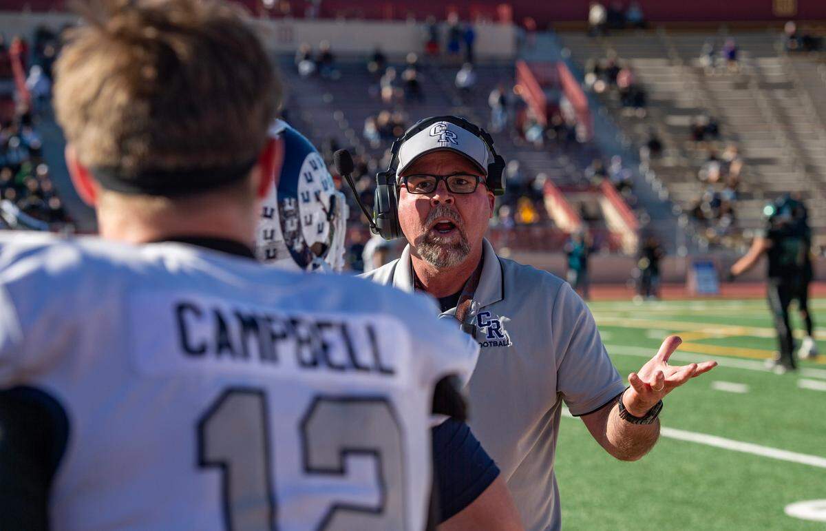 Casa Roble coach Chris Horner talks to quarterback Connor Campbell (12) during the 2023 CIF Sac-Joaquin Section Division V football championship game.
