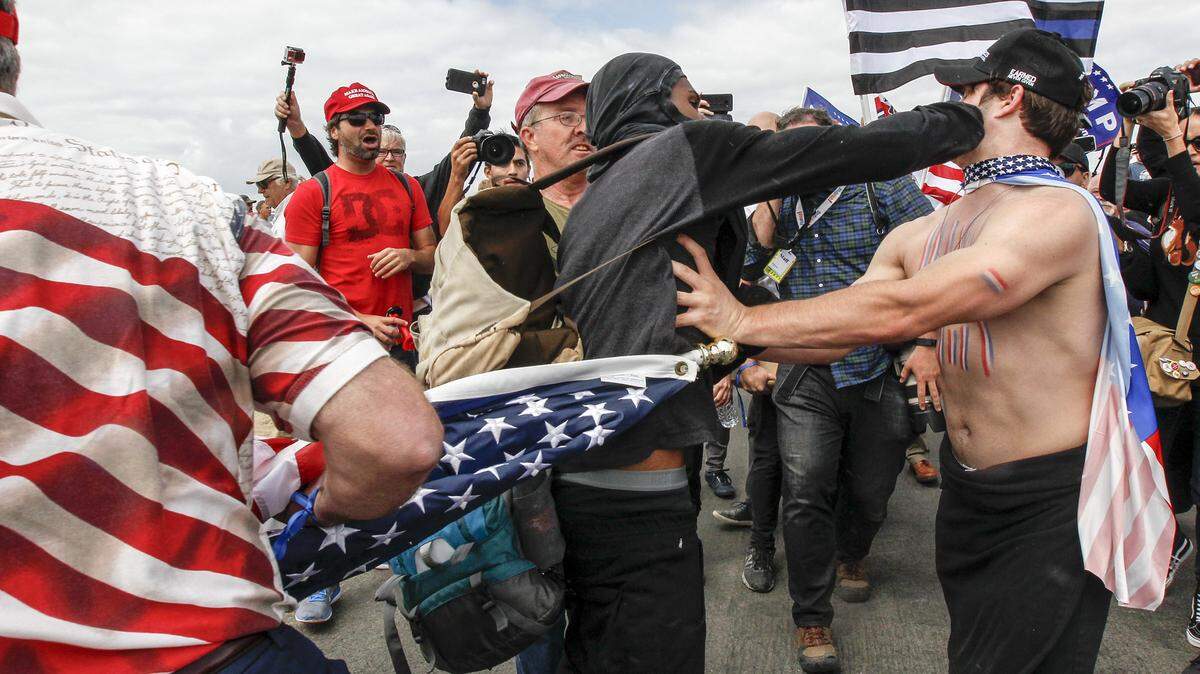 Supporters of President Donald Trump scuffle with counter-protesters during a rally on Saturday, March 25, 2017, in Huntington Beach. A Sacramento woman who slapped a man at a Southern California “Make America Great Again” rally in support of President Donald Trump in 2017 was convicted in the attack, Orange County District Attorney’s officials said Thursday.
