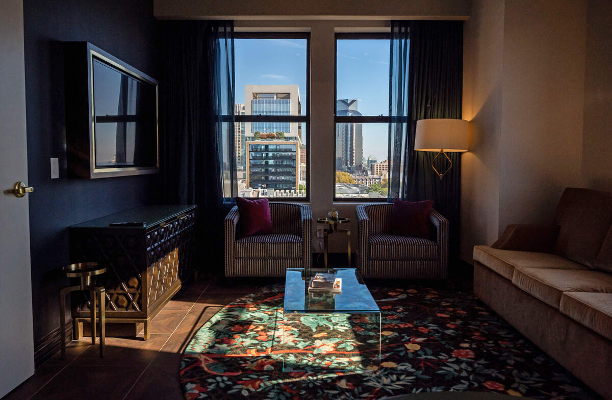 The downtown skyline – including the Sawyer Hotel – gleams in the windows of a 10th floor king suite at The Exchange Sacramento, a boutique hotel part of the Curio Collection by Hilton. 