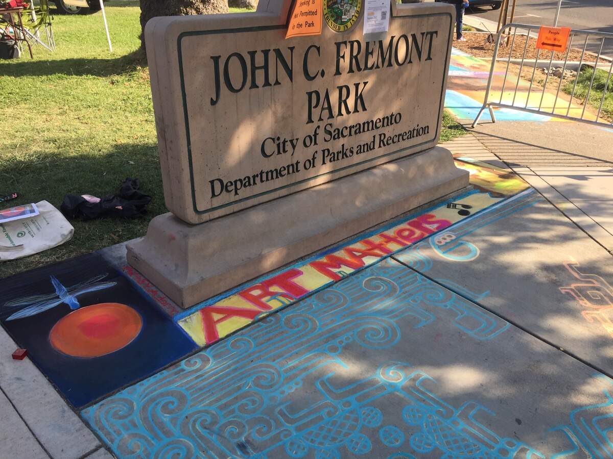 A slogan, “Art Matters,” and a dragonfly by artist Mary Adorno adorn the concrete for Chalk It Up, an annual festival held each Labor Day weekend at Fremont Park in Sacramento, Sunday, Sept. 2, 2018.