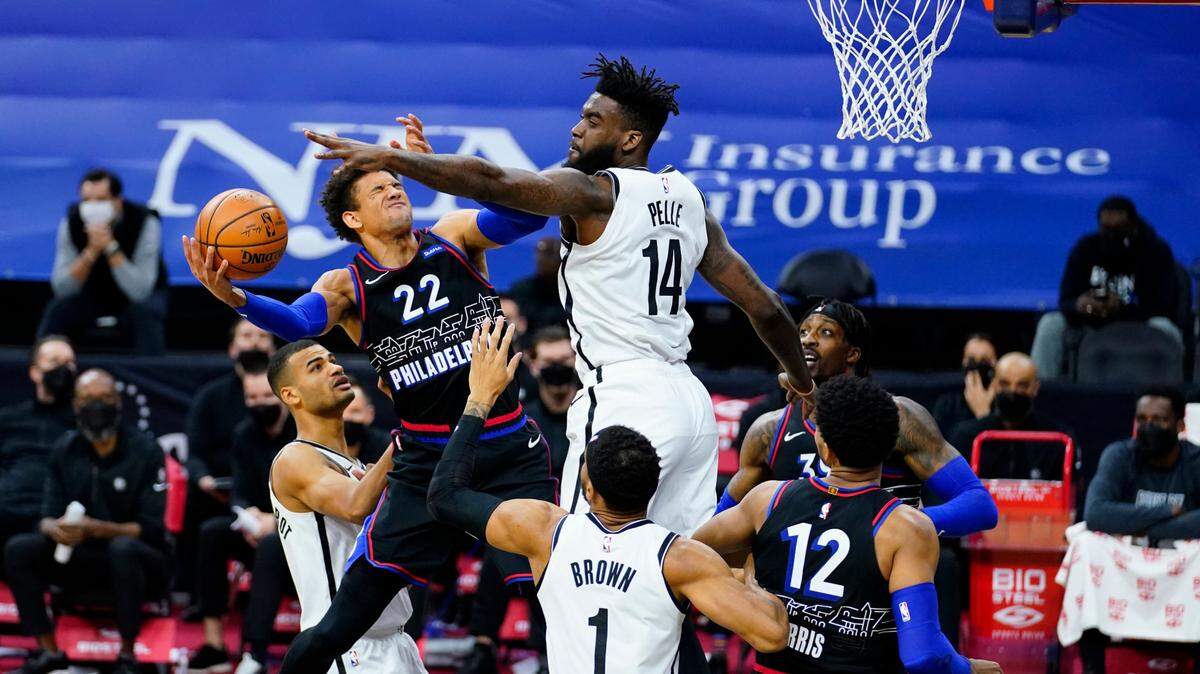 Philadelphia 76ers’ Matisse Thybulle (22) tries to get a shot past Brooklyn Nets’ Norvel Pelle (14) during the second half of an NBA basketball game, Saturday, Feb. 6, 2021, in Philadelphia. (AP Photo/Matt Slocum)