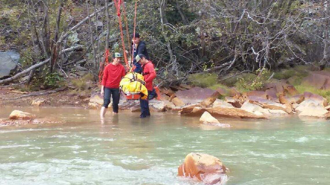 Rescuers use a rope system to pull a woman who broke her leg while hiking across a Colorado river. The woman flagged down a passing train after two nights in the wilderness.