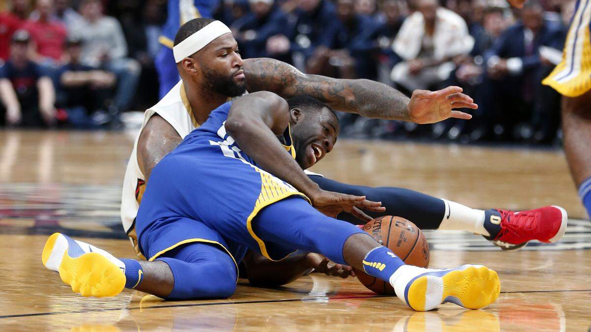 New Orleans Pelicans center DeMarcus Cousins, top, and Golden State Warriors forward Draymond Green battle for a loose ball Dec. 4, 2017, in New Orleans. Cousins and Green will be teammates with Golden State.