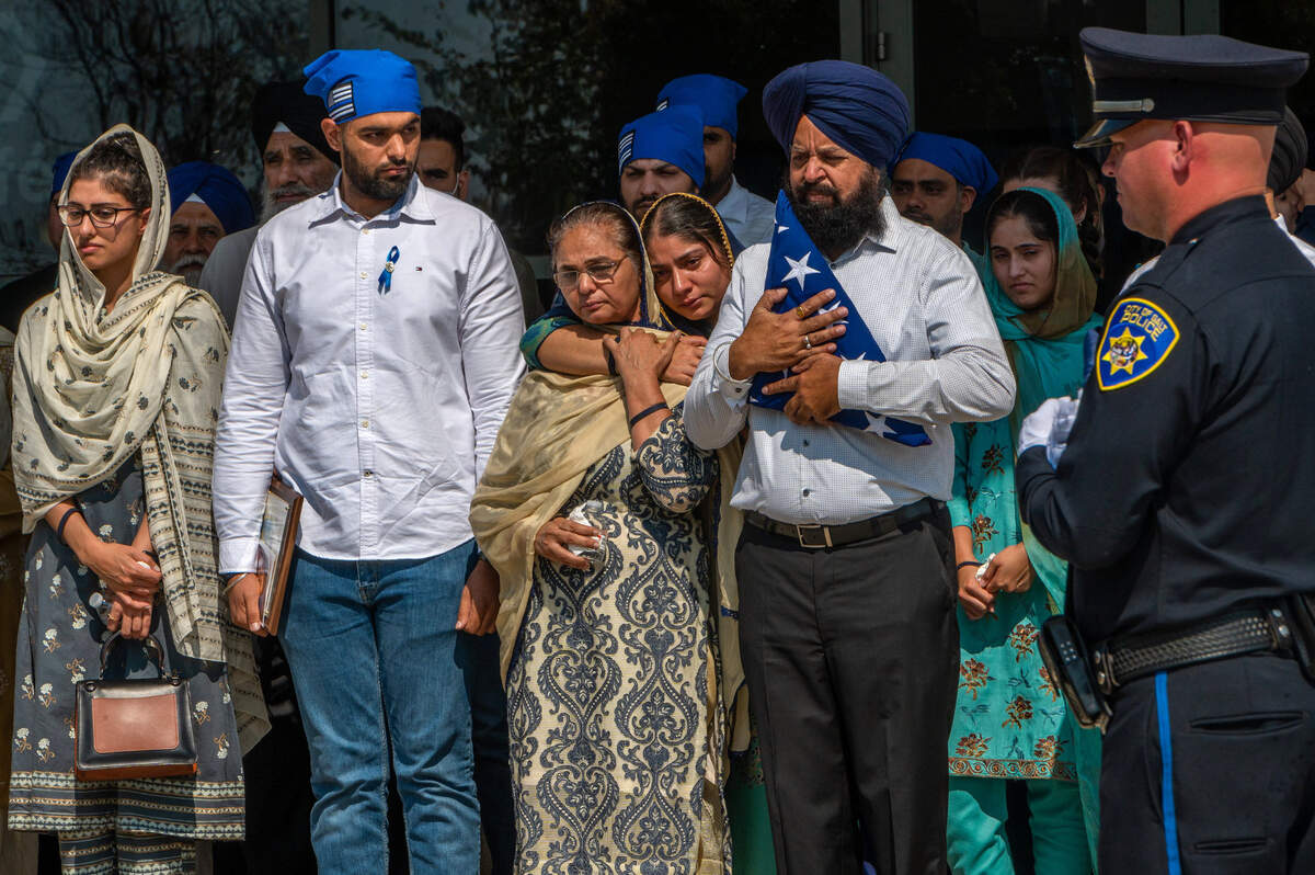 1. Gurdip Singh Grewal, father of Galt Police Officer Harminder Grewal, holds the flag that was draped over his son’s coffin at the memorial at Bayside Church’s Adventure Campus in Roseville on Monday, Sept. 13, 2021. Members of the Sikh community and police officers from as far as New York attended the service. Officer Grewal died from injuries when his patrol car was struck head-on by a pickup truck on Highway 99 near Dillard Road.
