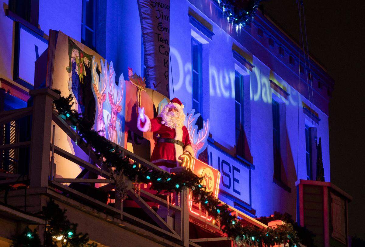 Santa and his reindeer make an appearance in a live dramatization on a balcony above K Street in historic Old Sacramento during a Theatre of Lights performance Friday, Dec. 18, 2021. The immersive performance is free.