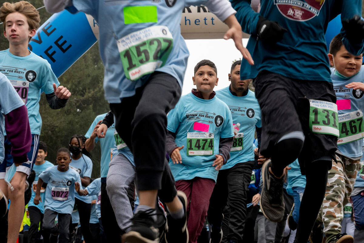 Participants in the Runnin’ for Rhett fitness program take off from the starting line at the "Run Because You Can" 5K at Sacramento’s Crocker Park on Saturday, Dec. 4, 2021. 